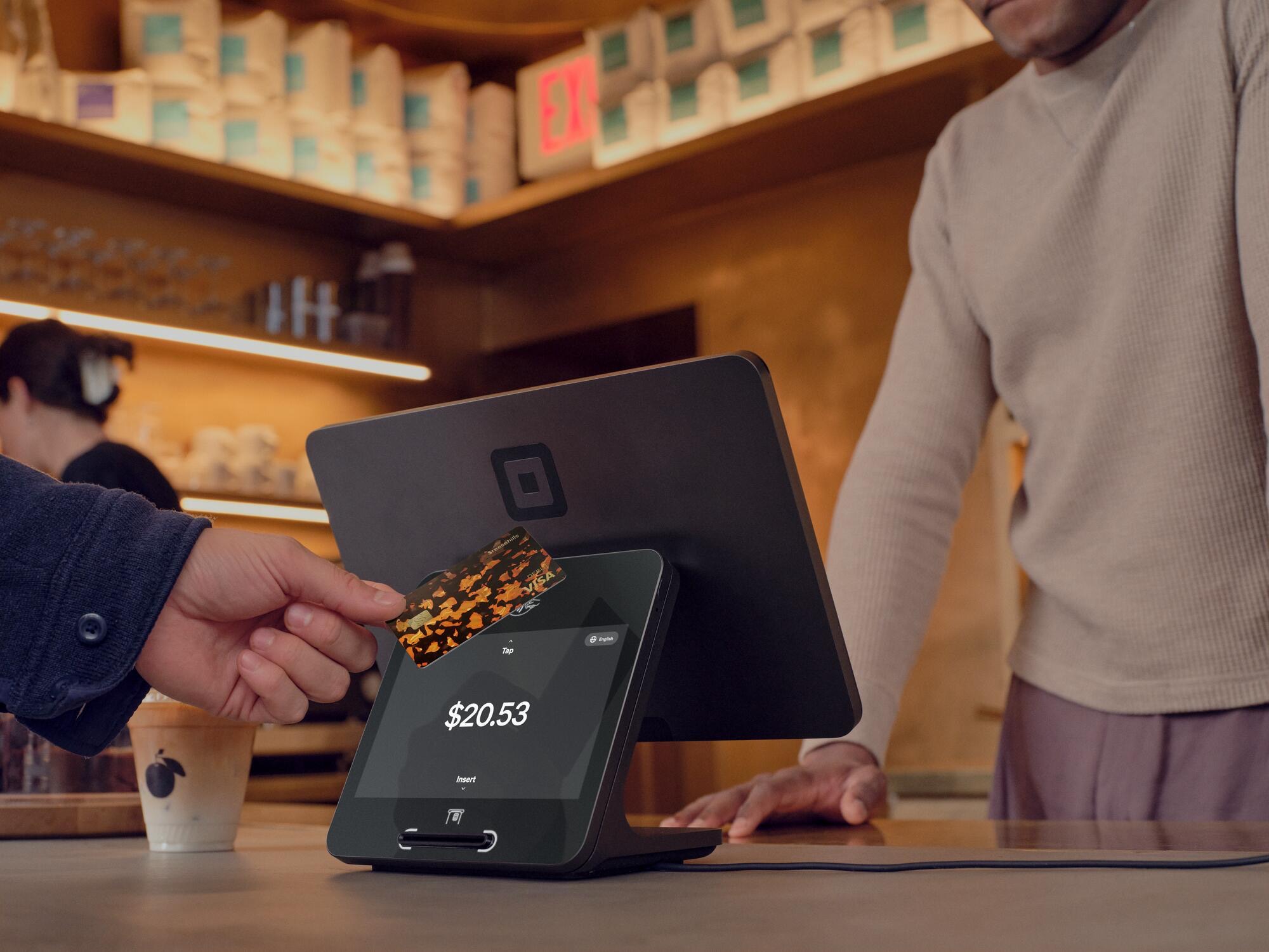 A payment terminal beside a shop counter